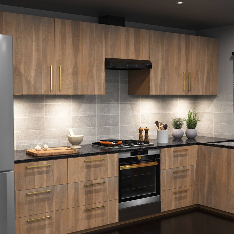 A full kitchen with wooden cabinets and a worktop illuminated by natural white slim under-cabinet lights.