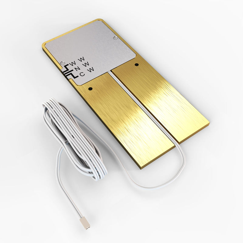 The back of the brushed brass under cabinet light showing the wire and its connection, and the colour temperature side switch.