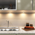 mid shot of a kitchen with mounted matte white LED CCT cabinet lights - warm white light