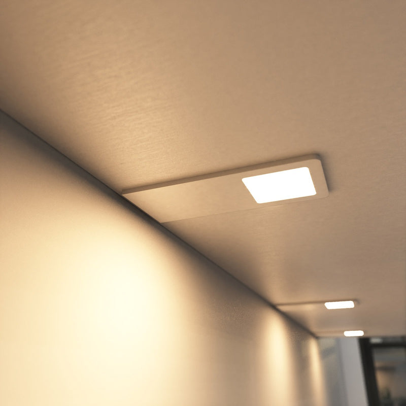 close up of a mounted matte white CCT LED cabinet lights - warm white light