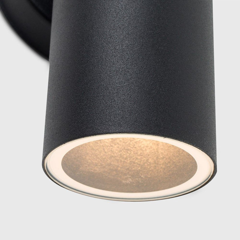 Close up of a Black Outdoor Up/Down Wall Light with warm white light