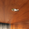 close up shot of a mounted chrome tilted downlight