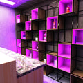 close up of a bar shelf with purple strip lights