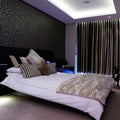 Full shot of a bedroom with LED tape with cool white light in the ceiling 
