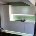 Full shot of a kitchen with LED tape with cool white light under the cabinets