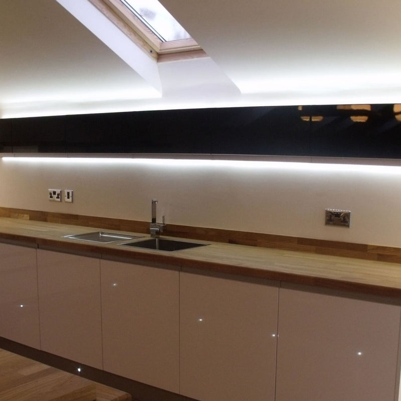 Side shot of a kitchen cabinet with LED tape with cool white light