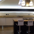 Front shot of a kitchen cabinet with LED tape with cool white light