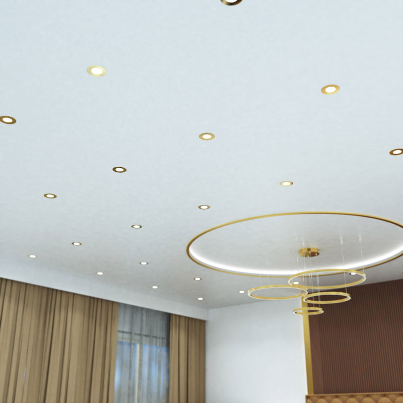 mid shot of a ceiling that has mounted brass LED downlights with cool white light