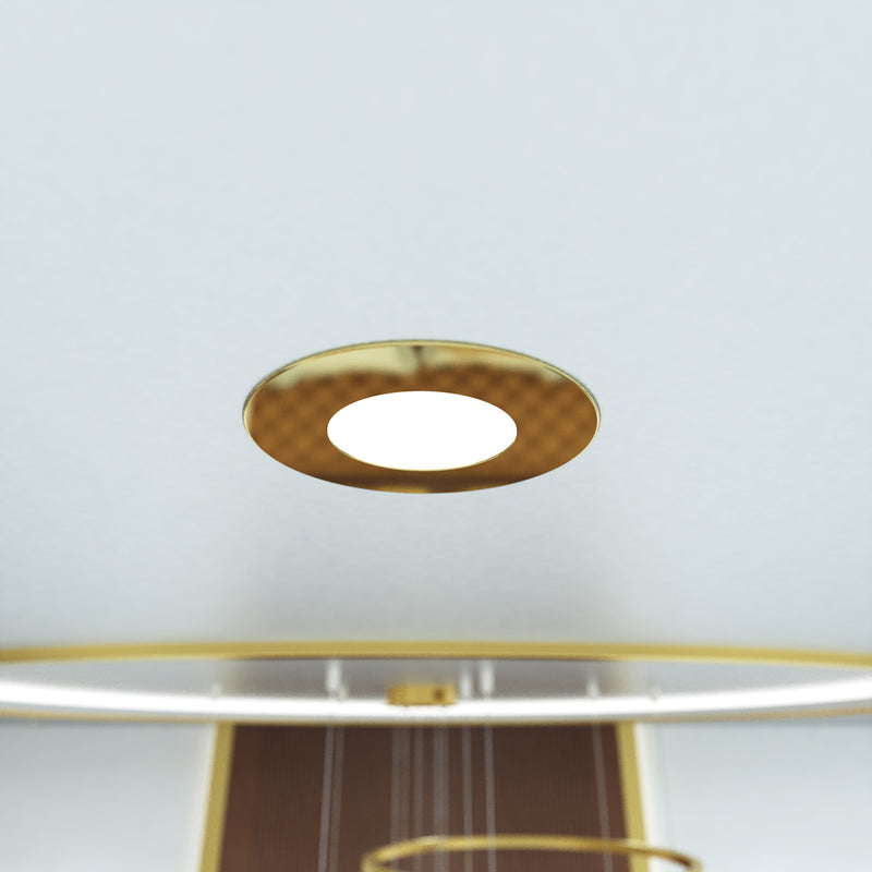 clos up shot of a ceiling that has mounted brass LED downlight with cool white light