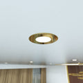 close up shot of a ceiling that has mounted brass LED downlights with cool white light