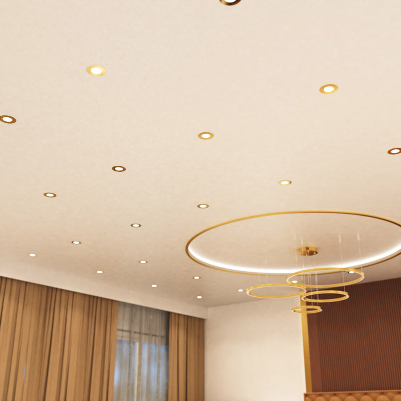 mid shot of a ceiling that has mounted brass LED downlights with natural white light