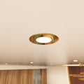 close up shot of a ceiling that has mounted brass LED downlights with natural white light