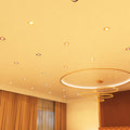 mid shot of a bedroom that has brass LED downlights with warm white light