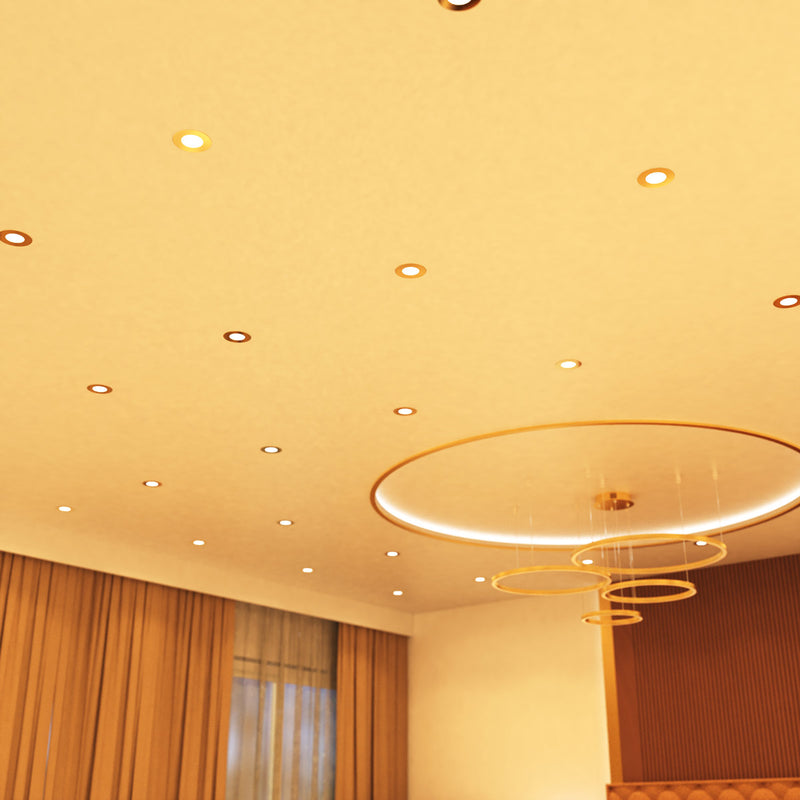 mid shot of a ceiling that has mounted brass LED downlights with warm white light