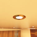 close up shot of a ceiling that has mounted brass LED downlights with warm white light