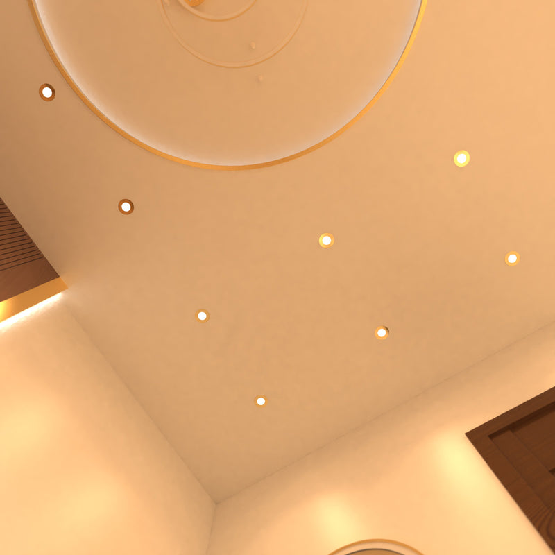 mid shot of a ceiling that has mounted brass LED downlights with warm white light
