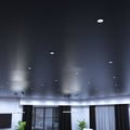 mid shot of a living room with mounted matt black CCT fire-rated downlights in cool white 