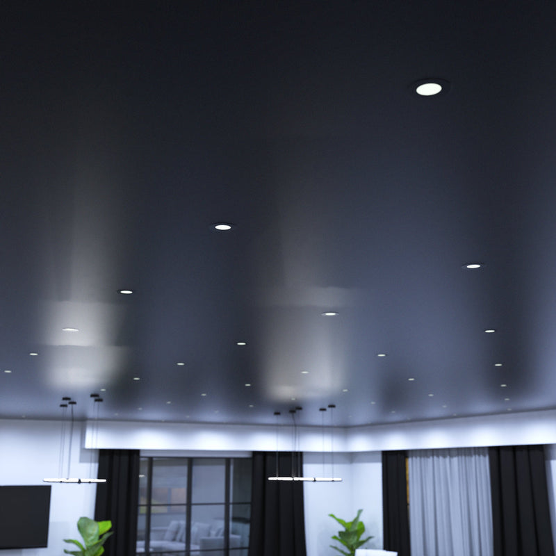 mid shot of a living room with mounted matt black CCT fire-rated downlights in cool white 