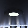 close up of a mounted matt black CCT fire-rated downlight in cool white 