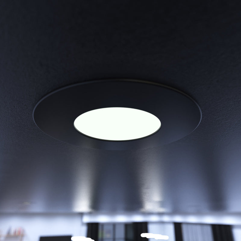 close up of a mounted matt black CCT fire-rated downlight in cool white 