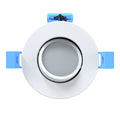 Adjustable downlight with white bezel and a tilted gimbal