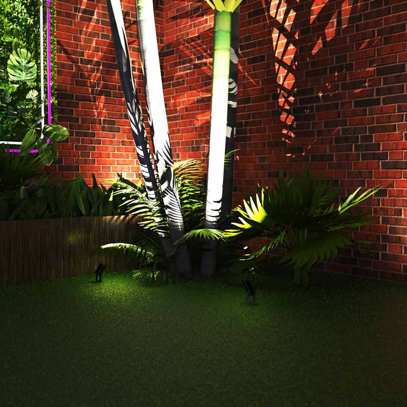 mid shot of a garden with spike lights pointed at a tree
