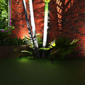 Garden with a spike lights pointed at a tree