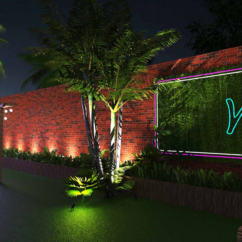 mid shot of a garden with a spike light pointing to a tree