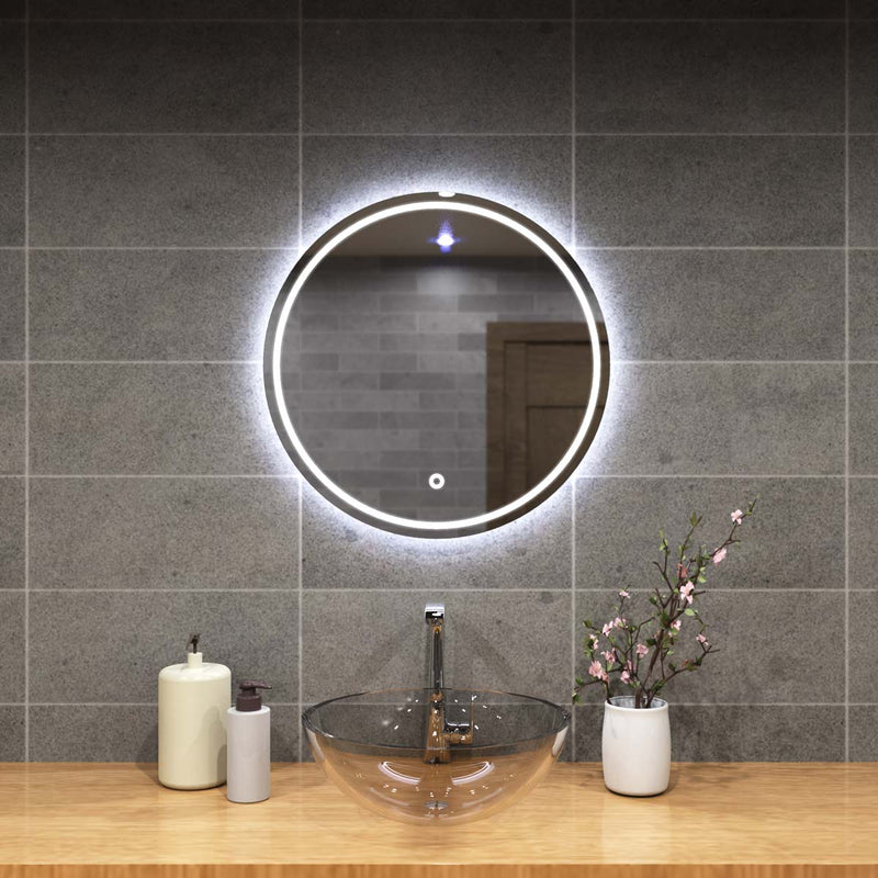 mid close up of a circular bathroom mirror with cool white light