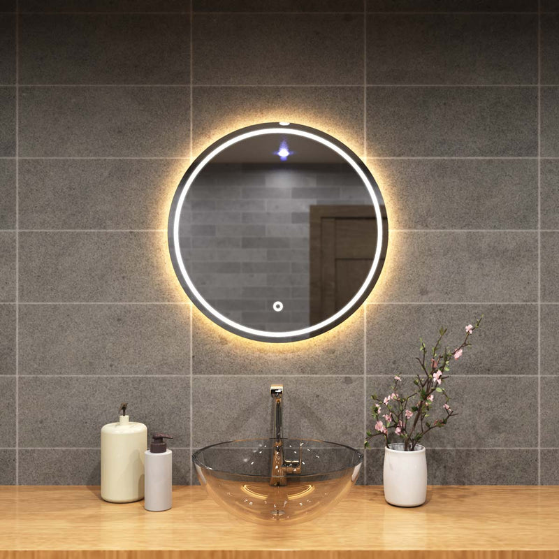 mid close up of a circular bathroom mirror with warm white light
