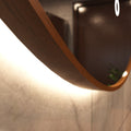 LED Bathroom mirror - Walnut in warm white light backlit close up