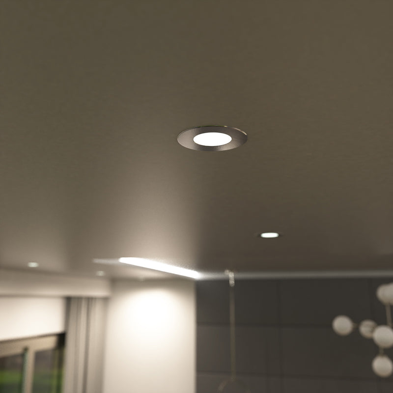 medium close up shot of a mounted natural white brushed chrome downlight