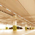 parking that has hanging LED battens with warm white light