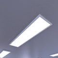 close up of a ceiling with surface-mounted LED panels with cool white light
