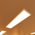 close up of a ceiling with surface-mounted LED panels with warm white light