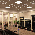 side-shot of an office with mounted edge-lit LED panels in natural white light