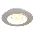 Close-up on a round LED cabinet light with warm white light