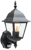 A black wall lantern with clear glass panels and a warm light bulb on a white background.