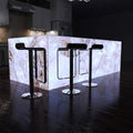 side shot of a kitchen with an illuminated island in cool white light
