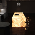 side shot of a kitchen with an illuminated island in warm white light