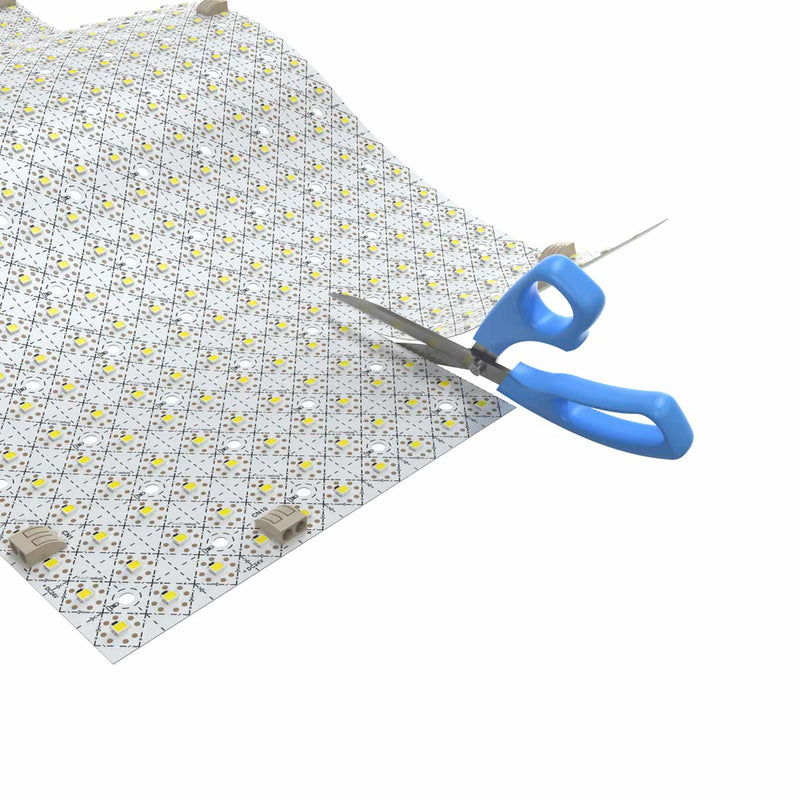 LED sheet being cut with a scissor