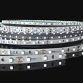 Cool white led tape on a black background, zoomed into the pcb