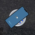 Close-up of a charging phone via QI charger
