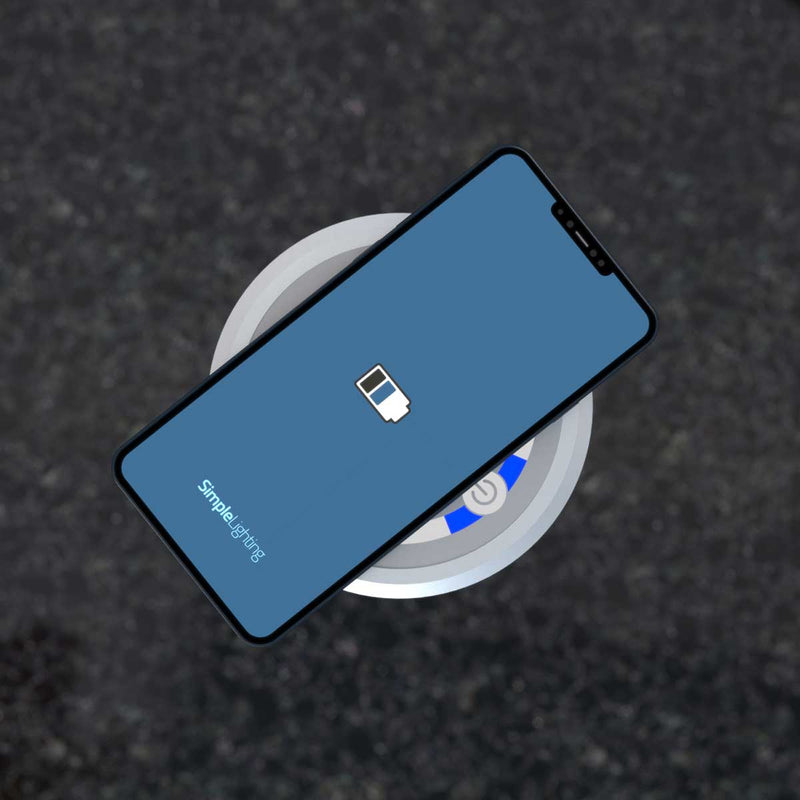 Close-up of a charging phone via QI charger