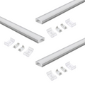 Three sets of aluminium profiles with a white finish and white diffuser covers laid on a white surface with two mounting brackets and end caps for each profile.