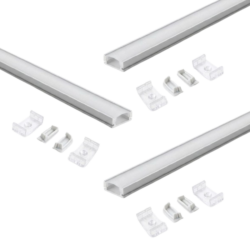Three sets of aluminium profiles with a white finish and white diffuser covers laid on a white surface with two mounting brackets and end caps for each profile.