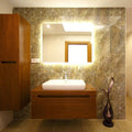 Full shot of a bathroom with LED tape in warm white light around the edge of a mirror