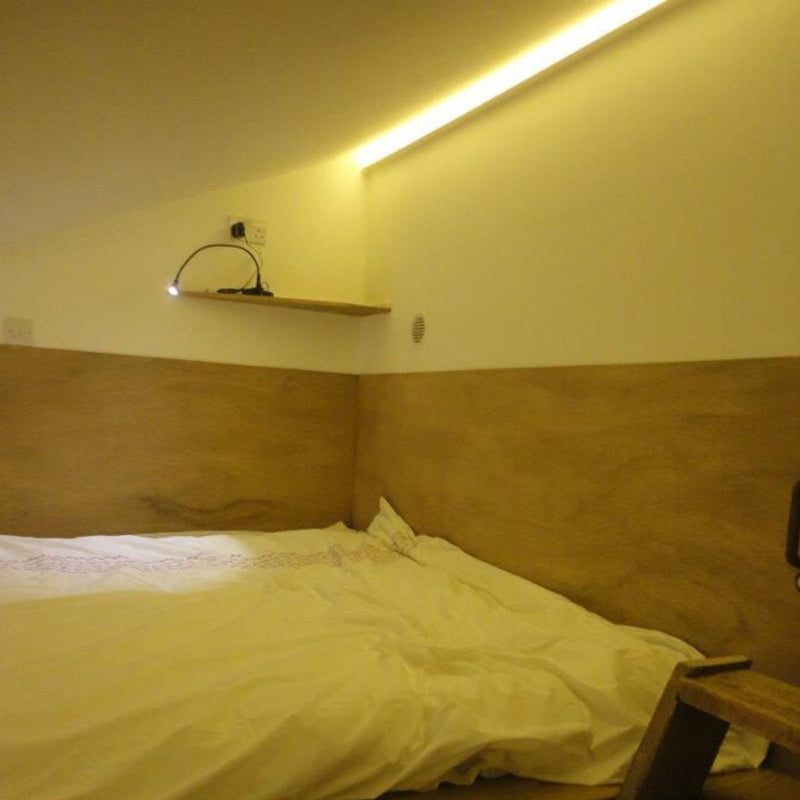 Side shot of an LED tape in warm white light on the wall