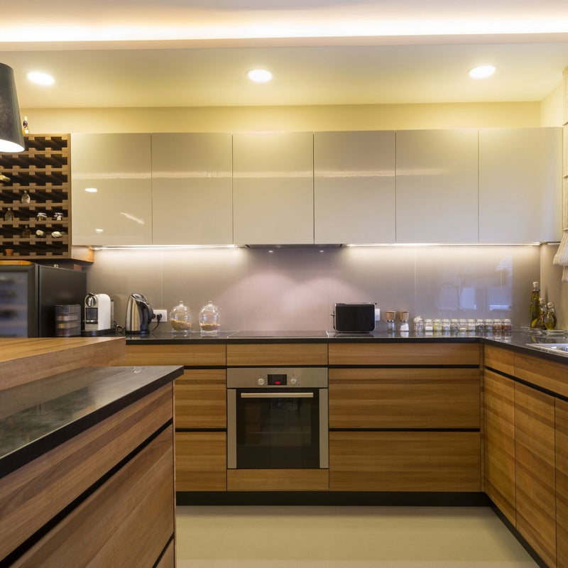 Full shot of a kitchen with LED tape in warm white light on the ceiling